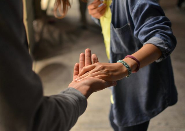 two hands meeting palm to palm